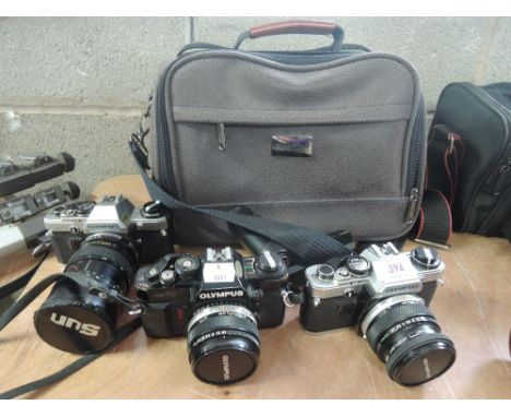 A Shilton camera bag with an Olympus 10 Motodrive 2x manual adapters 50mm 1:1,8, and Olympus 10 with sun 28-80mm 1;3,5-4,5 le