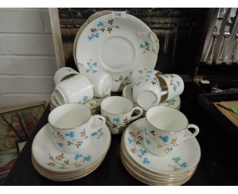 A vintage tea service un marked with blue flower enamel detailing