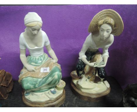 Two large ceramic figurines on treen bases