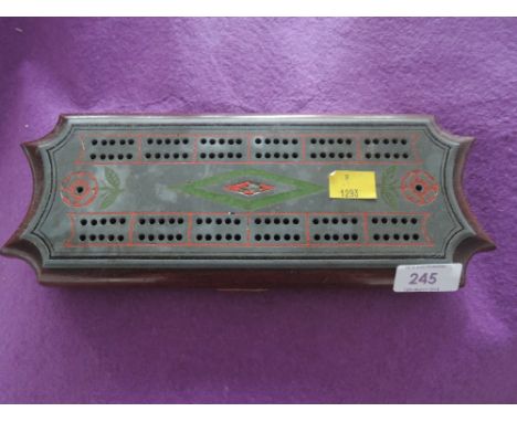 A vintage cast and treen cribbage score board with pieces
