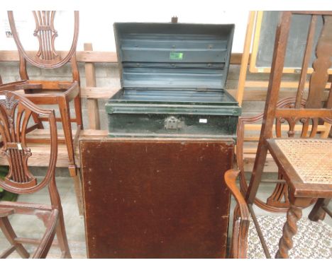 A vintage tin trunk and folding card table