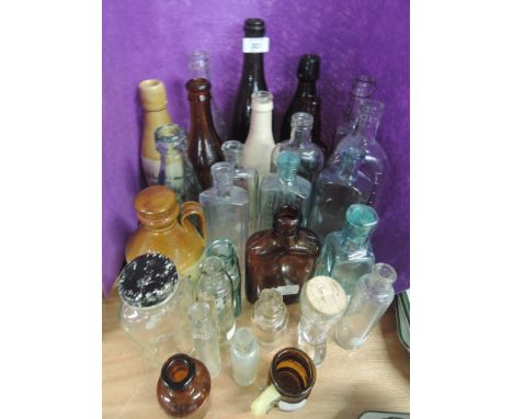 A selection of vintage advertising bottles some glass some ceramic