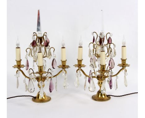 A pair of four-light table lights, hung prismatic glass drops with gilt metal mounts, 49cm high