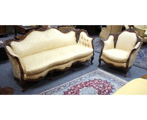 A Victorian style three-seater sofa with pierced and carved frame, on cabriole legs, 209cm wide and a matching armchair