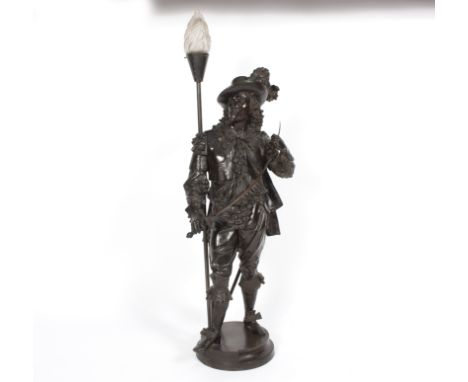 A figural table light, the bronzed metal cavalier support holding a sword, on a circular base, 110cm high