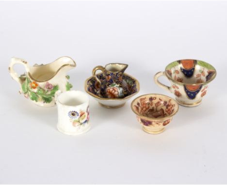 A group of early 19th Century toy porcelain, comprising an Imari pattern jug and basin, a footed bowl, a teacup, a flower enc