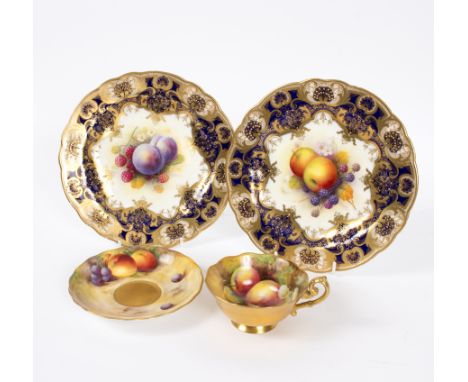 A pair of Royal Worcester porcelain cabinet plates, each painted with fruit by Albert Shuck, signed A. Shuck, within a blue a