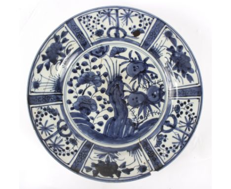 An English blue and white delftware plate with floral stylised decoration, 36cm diameter