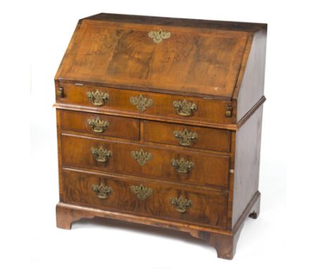 An 18th Century walnut and feather banded bureau, the fall front enclosing a fitted interior with well above two short over t