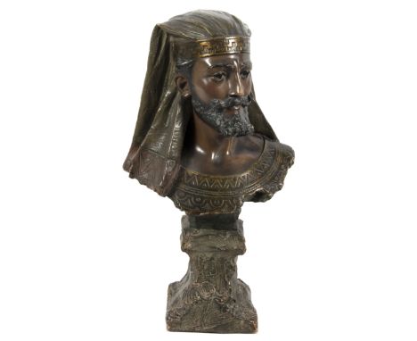 A bronzed terracotta bust in the manner of Friedrich Goldscheider, modelled as an Arab man in a headdress, monogrammed verso,