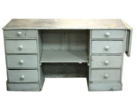 A 19th Century painted shop counter, with bank of four drawers flanking a shelf and with drop flap to one end, 195cm wide, fl