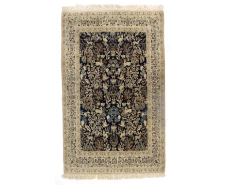 A Qum silk Tree of Paradise rug with numerous birds and animals on a dark blue ground, 188cm x 109cm/see illustration   Condi