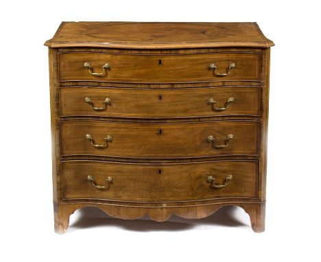 A George III mahogany serpentine dressing chest, the top drawer with leather inset slide above various lidded compartments, a