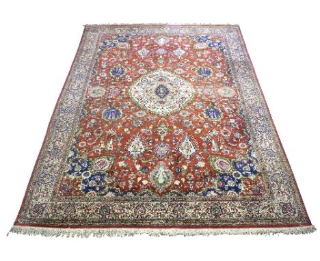 An Isfahan carpet, the red and blue field with birds, flowers and urns, within a pale main border, approximately 300cm x 196c