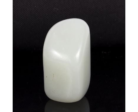 A jade worry stone of pale celadon colour, 5cm long