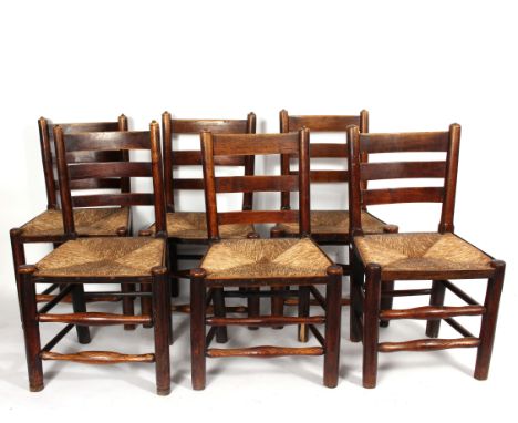 A set of six 19th Century oak ladder back chairs with rush seats, on turned legs with stretchers/Provenance: The Old Manor Ho