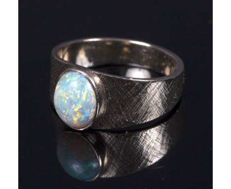 An opal ring to a textured 14k gold shank   Condition Report:  The Opal has some surface abrasions and wear. It measures appr