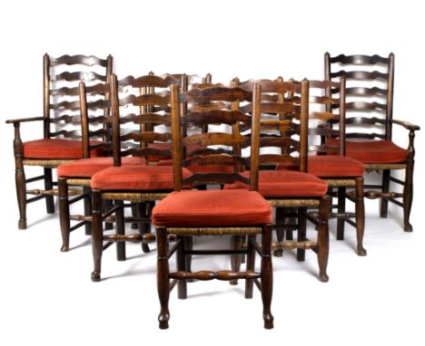 A set of ten ladder back chairs, with rush seats on turned front legs united by turned stretchers (eight chairs, two carvers)