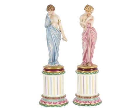 A pair of Royal Worcester figures, Joy and Sorrow, each modelled as a classically draped maiden holding a bird, each with pli