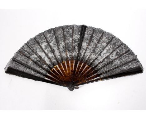 A black lace fan with tortoiseshell sticks, a tortoiseshell comb, a pair of tortoiseshell glove stretchers and a pair of lorg