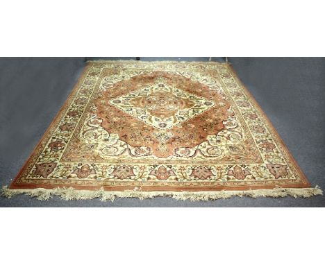 A Chinese carpet, decorated foliate scrolls to an ivory and brown ground, 310cm x 245cm