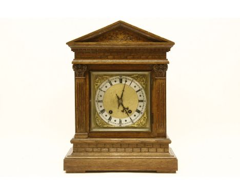 A German (?) oak mantel clock, with striking movement. 41cm high