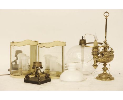 A brass table lamp, in the form of an oil lamp a pair of modern cream painted stable lamps, a lamp base with scrolling suppor