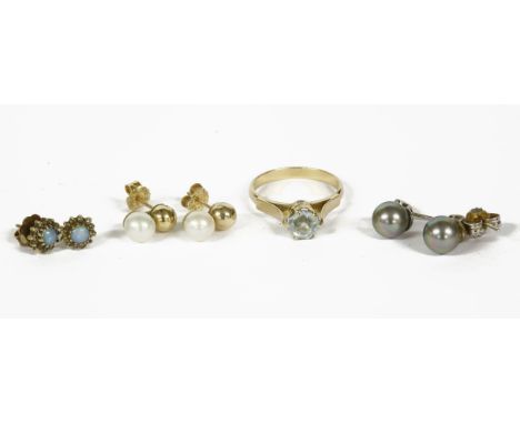 A gold single stone aquamarine ring (tested as approximately 18ct), a pair of gold sphere and cultured pearl earrings (tested