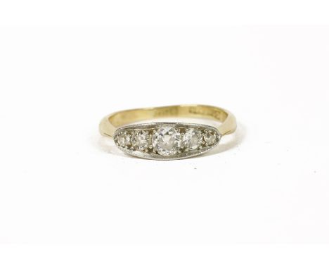 A gold five stone graduated diamond boat shaped ring, marked 18ct and Plat, size I½1.99g