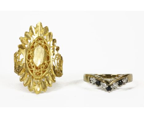 A high carat gold diamond cut lozenge shaped ring, with open work shoulder (approximately 21ct gold), and a silver gilt sapph