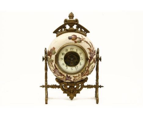 A Victorian pottery and spelter mantel clock, decorated with thistles, with visible movement, 37cm high