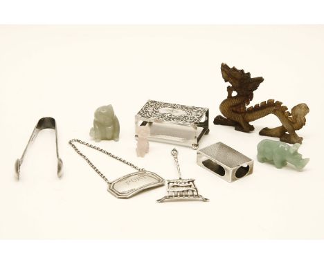 A small assortment of silver, to include matchbox holders, tongs, decanter labels, and carved hardstone figures