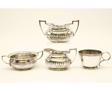 A 20th century silver cream jug with half gadrooned body, together with a matching sugar bowl, marks for London, together wit