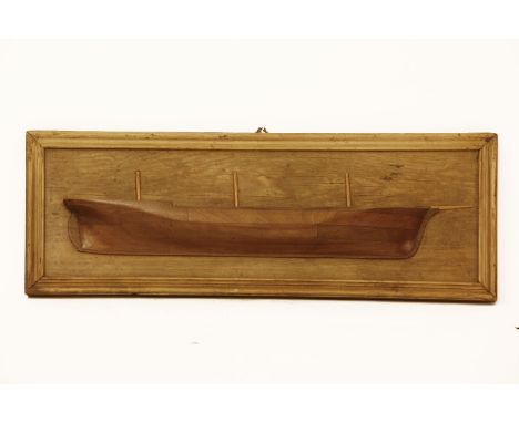 A late 19th century mahogany half hull model of a ship
