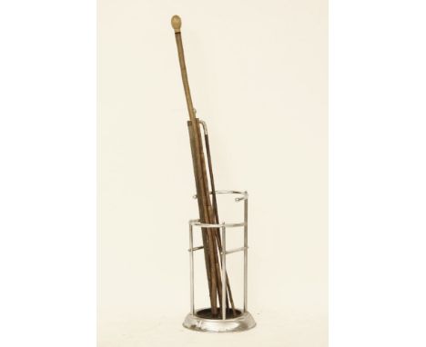 Sword sticks, a Malacca walking stick with a silver handle all within a chromed stick stand