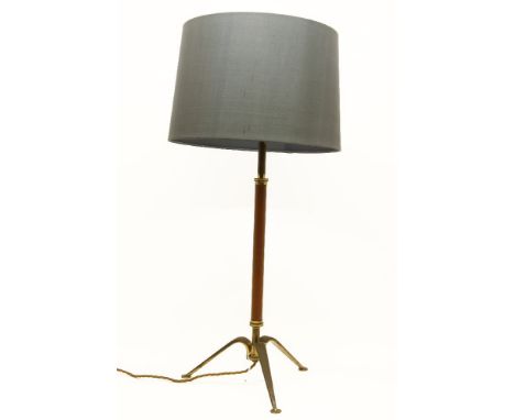 A Continental brass and leatherette mounted table lamp, on tripod base and grey shade, 54cm tall overall