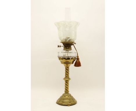 A Victorian brass oil lamp with glass reservoir and shade, 72cm high