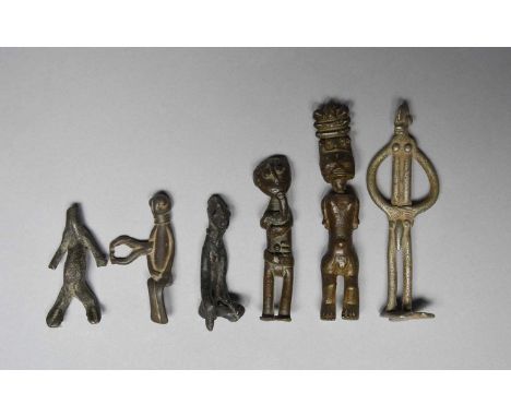 Six West African metal figures including a Senufo bronze pendant of a seated figure, 6.6cm long, a Senufo bronze seated figur