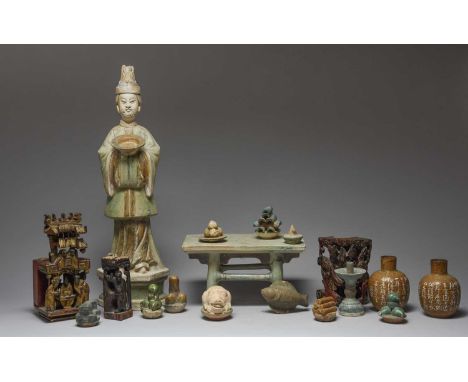 A Chinese pottery altar table with nine offeringsincluding a fish, a pig's head, fruit, and split bamboo, together with two c