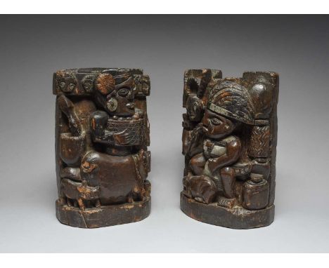 A pair of Paiwan panelsTaiwanone carved a woman carrying a basket of fruit, with a pig and piglet below, a mortar and pestle,