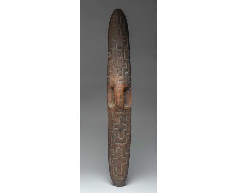 An Aboriginal shieldWestern Austaliawith an integral handle and carved bordered cross designs, the front plain with a black p