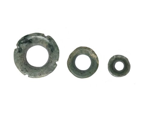 A Maya ear ornamentMexico, circa 300 - 500 ADjade, of three graduated circular rings with flared rims, the largest with four 