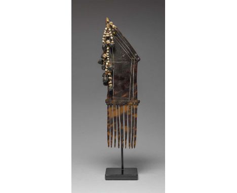 λA Collingwood Bay combPapua New Guineaturtleshell, shell beads, seeds and glass beads,26cm high, on a stand. (2)