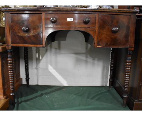 A Late 19th century Bow Fronted Side Table with Centre Drawer Flanked by Deeper Drawers Either Side, Turned Bobbin Supports, 