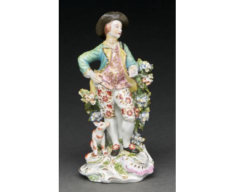 A Derby figure of a Garland Shepherd, c1770, in a green jacket, pink waistcoat and flouretted breeches before bocage on pink,
