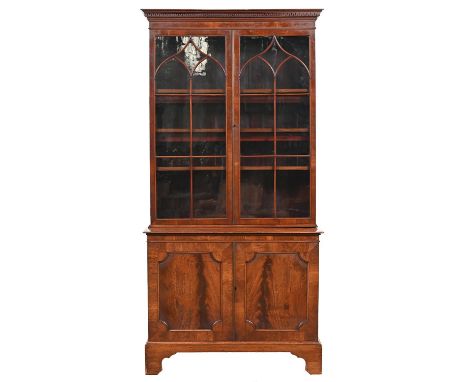 A George III mahogany bookcase,&nbsp; with stepped key fret cornice and fitted with adjustable shelves enclosed by a pair of 