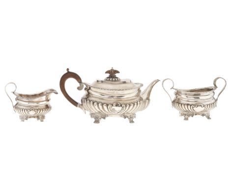 A Victorian silver tea service, of partly lobed oblong shape, the lid with integral joint, on four feet, teapot 12cm h, marks