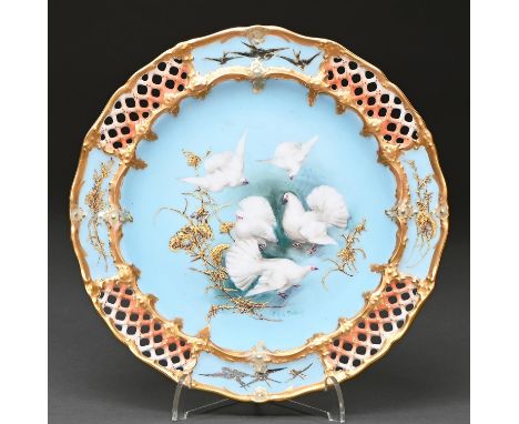 A Royal Worcester plate, 1906, painted by C H C Baldwyn, signed, with fan-tailed pigeons and raised gilt foliage on a matt sk