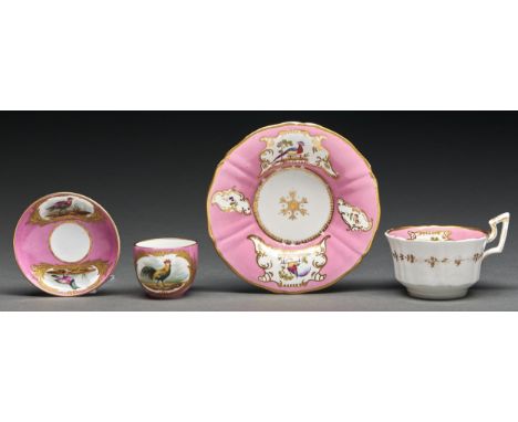 A Staffordshire pink ground bone china tea cup and saucer, c1825, painted with fancy birds and flowers in gilt reserves, sauc