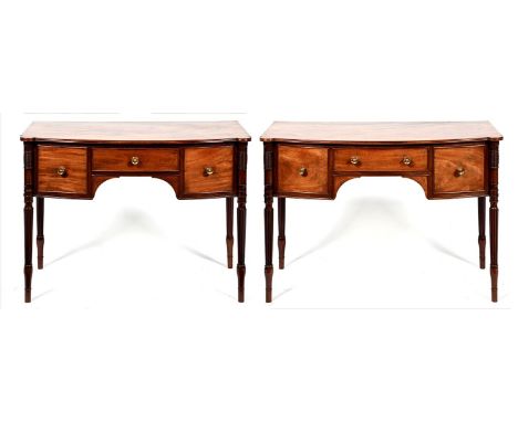 Two similar bow fronted English mahogany sideboards, 19th c, fitted with three drawers about the arched apron, on ring turned